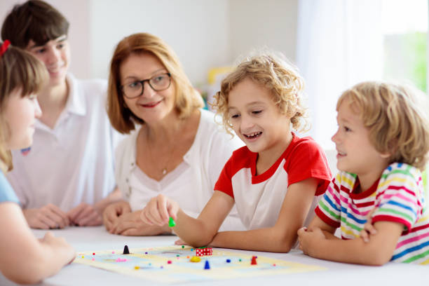 istock Family playing board game. Kids play. 1323030039
