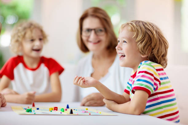 istock Family playing board game. Kids play. 1323030393