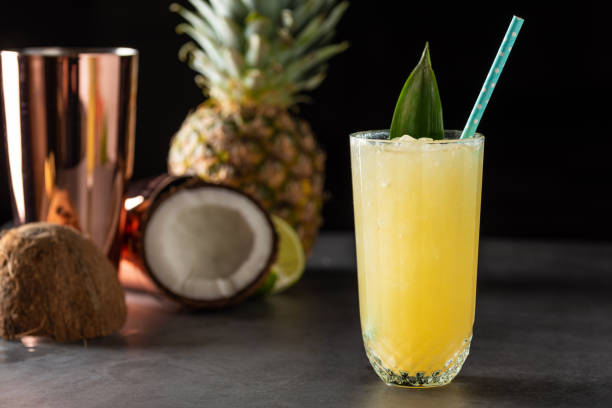 istock Cocktail with pineapple, coconut and lemon on stone background 1323031299