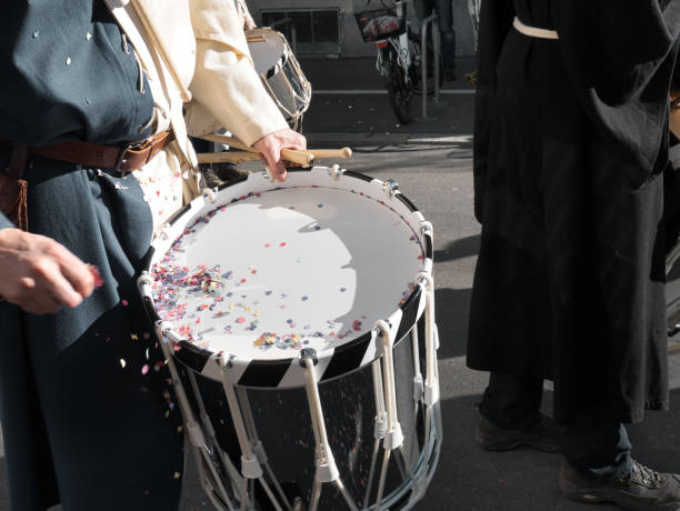 Drummer of a Guggenmusik, called Tambouren in Swiss German, at a carnival procession. Guggenmusik is a term widely used in the Alemannic region of Switzerland, Austria and southern Germany to designate both a Carnival marching band and the type of music it plays