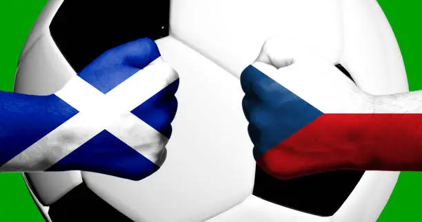 Flags of Scotland and Czech Republic painted on two clenched fists facing each other with closeup 3d football soccer ball in the background. Mixed media football match game concept