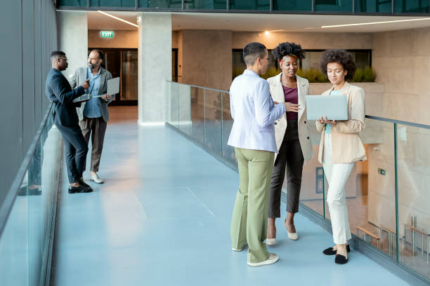 istock Diverse Businesspeople Talking in the Office Corridor 1323032776