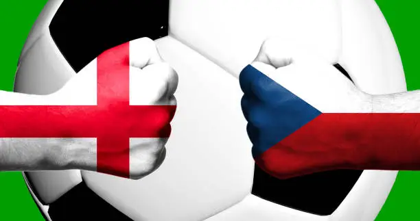 Flags of England and Czech Republic painted on two clenched fists facing each other with closeup 3d football soccer ball in the background. Mixed media football match game concept