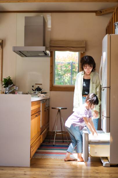 istock A girl cooking with her mother 1323033827