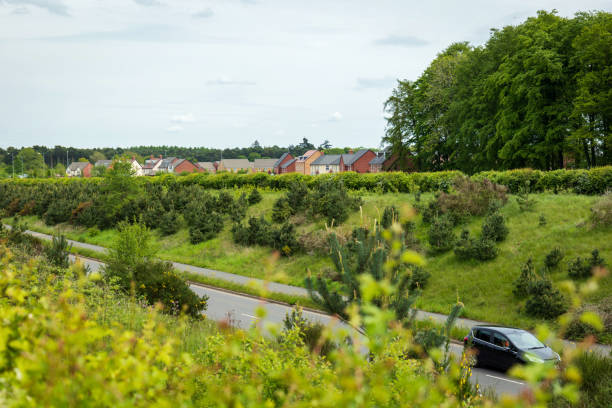 uk motorway road traffic over new build town development in england - town rural scene road new england imagens e fotografias de stock