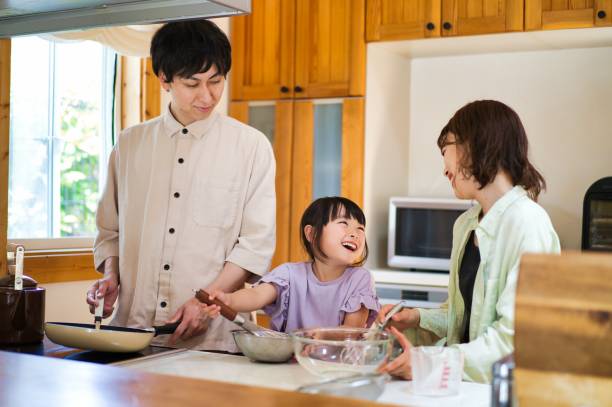 istock Family cooking together at home 1323035372