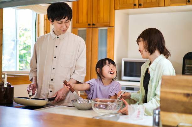 istock Family cooking together at home 1323035376