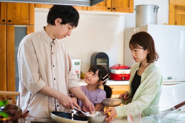 istock Family cooking together at home 1323035377