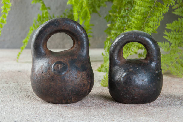 istock Antique iron weights for scales on concrete background. 1323035388