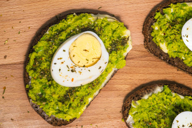 istock Sandwiches with avocado close-up. Toast with egg and mashed avocado. Food for breakfast, lunch or dinner. Healthy food, vegetarian snack 1323036507