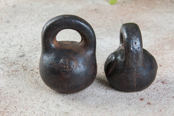 istock Antique iron weights for scales on concrete background. 1323036590