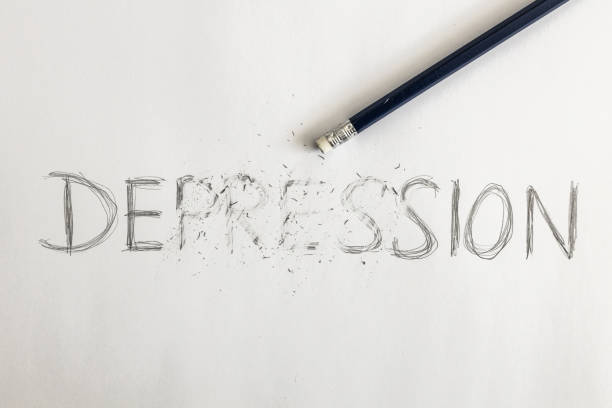 istock Erasing depression. depression written on white paper with a pencil, erased with an eraser. Symbolic for overcoming depression or treating depression. 1323038846