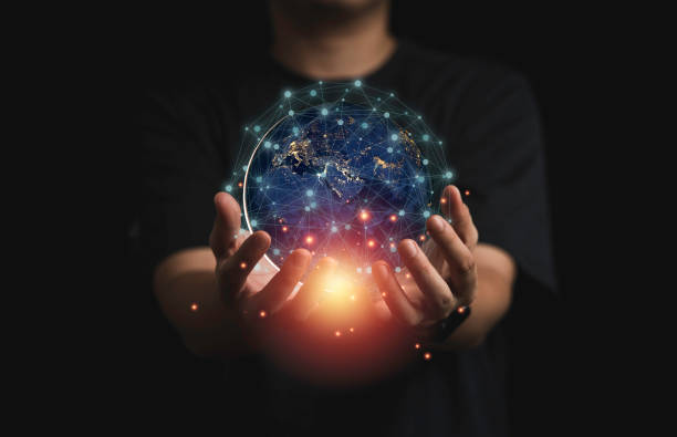 istock Businessman holding virtual world with orange light and connection line for global telecommunications concept. 1323040007