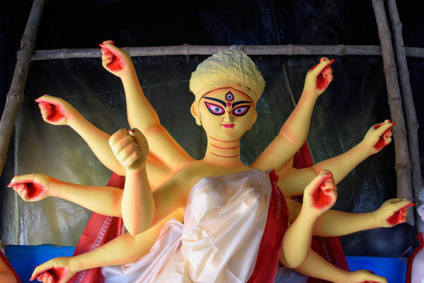 Goddess Devi Durga idol is under preparation for upcoming Durga Puja festival at a potter's studio in Kolkata. It is biggest festival of Hinduism, now celebrated all over the world. stock photo