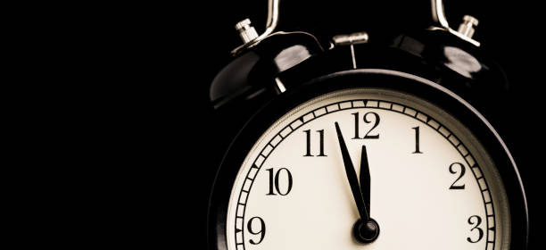 istock Black alarm clock with reflect on black background and copy space. 1323040288