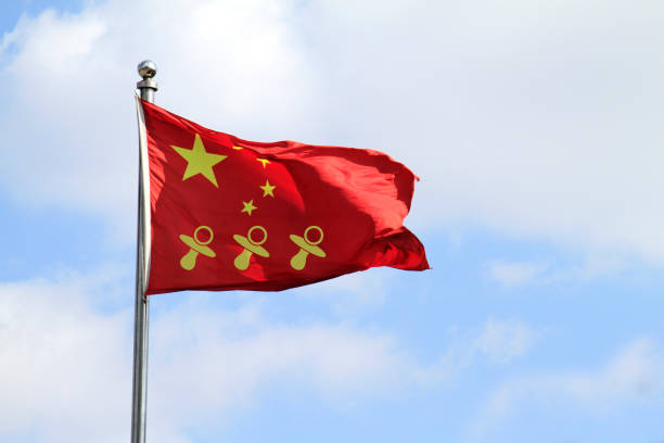 Three pacifier icons on a Chinese national flag - China allows three children in major policy shift announced in May 2021