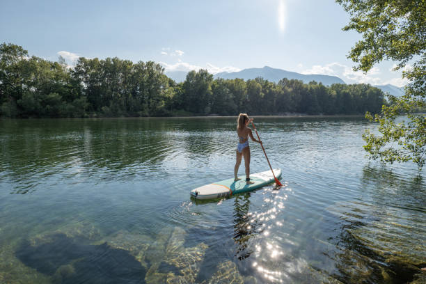 istock Woman paddling on a stand up paddle board 1323043191