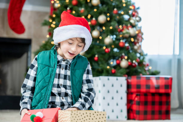 istock Young boy excited while looking at his Christmas presents 1323046229