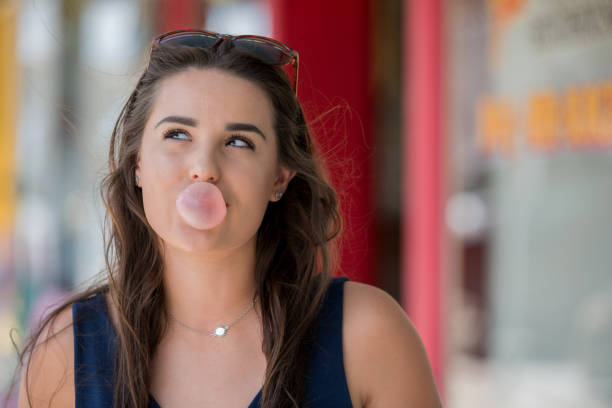 istock Young female blowing a bubble with her bubblegum 1323049126