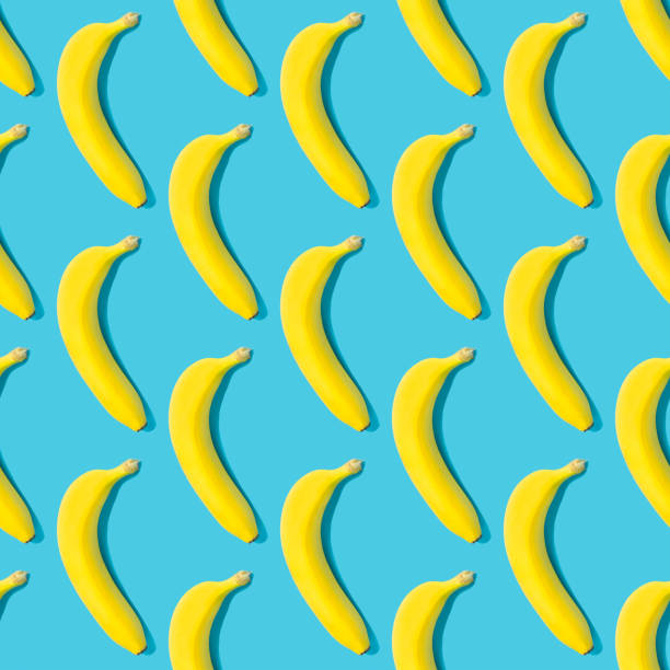 istock Seamless pattern with yellow ripe bananas on blue background. Fruit abstract seamless pattern. 1323049806
