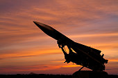 silhouette of an air defense missile against the background of dawn