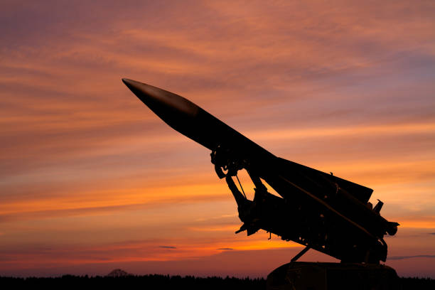 silhouette of an air defense missile against the background of dawn dark silhouette of a Soviet anti-aircraft missile against the background of the dawn sky russian military photos stock pictures, royalty-free photos & images