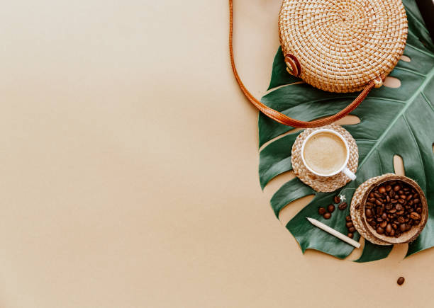 istock Monstera leaf ,coffee cup and Ratan bag on brown background. Copy space. summer minimal background flat lay, view from top 1323052047
