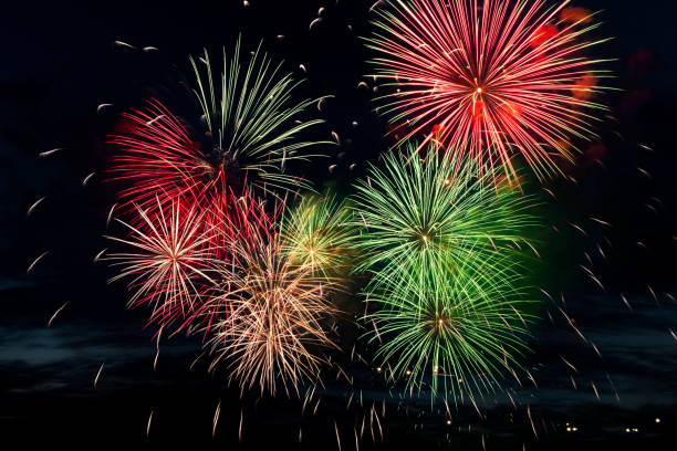 istock Bright colored fireworks on black background. Celebration and holidays concept. New Year, Independence Day, July 4 Festival. Bright explosions of lights in the sky. 1323052069