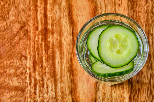 istock Refreshing water with cucumber in glass 1323052565