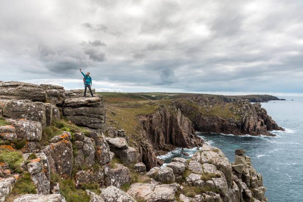 istock Man taking a selfie on a rock cliff enjoying the view 1323054402