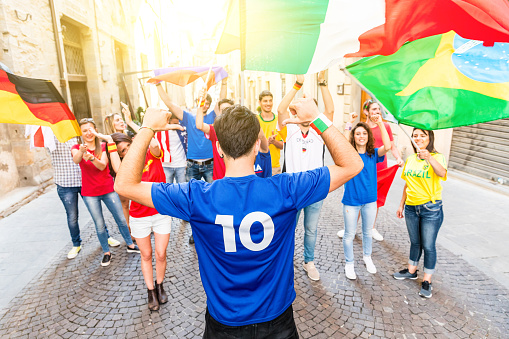 Happy football fan celebrating victory after match - Fans from different countries enjoying sport together - Sport, respect and fair play concepts