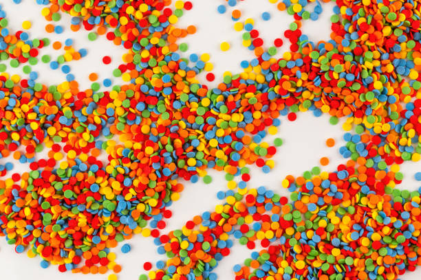 istock Vivid sugar sprinkle dots, decoration for cake on white background. Confectionery colorful decorative topping. 1323055672