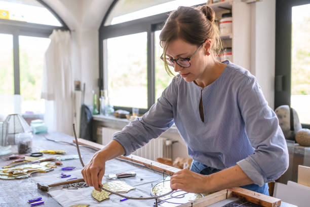 istock Glass artist craftswoman working in her studio 1323056459