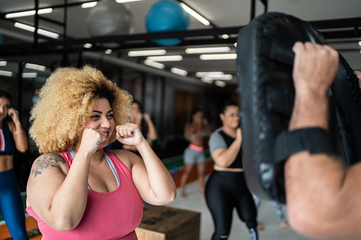 Woman on boxing training with fitness instructor
