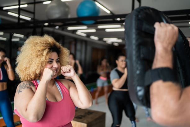 Woman on boxing training with fitness instructor Woman on boxing training with fitness instructor women boxing sport exercising stock pictures, royalty-free photos & images