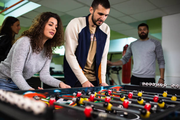 istock A group of young adults having fun playing foosball 1323056647
