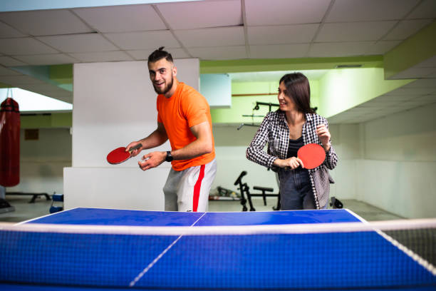 istock An attractive couple having fun playing table tennis 1323056675