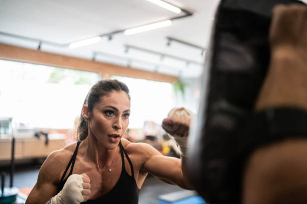 istock Confident female boxer practicing at the gym 1323057012