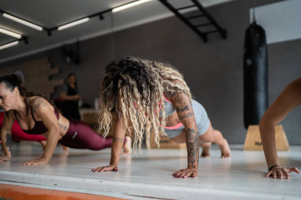 istock Group of women doing push ups exercise class at the gym 1323057705