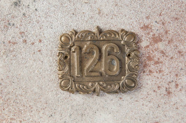 istock Old brass home number sign 1323058092