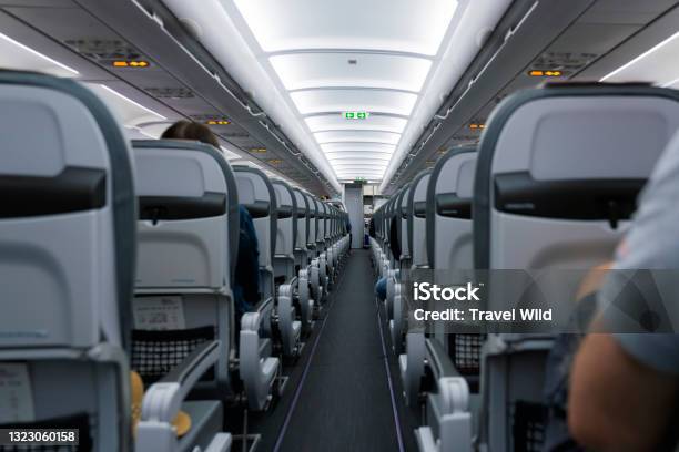 View Of An Aircraft Cabin With Passengers Ready For Departure Night Flying Concept Of Travel During The Covid19 Coronavirus Pandemic Stock Photo - Download Image Now