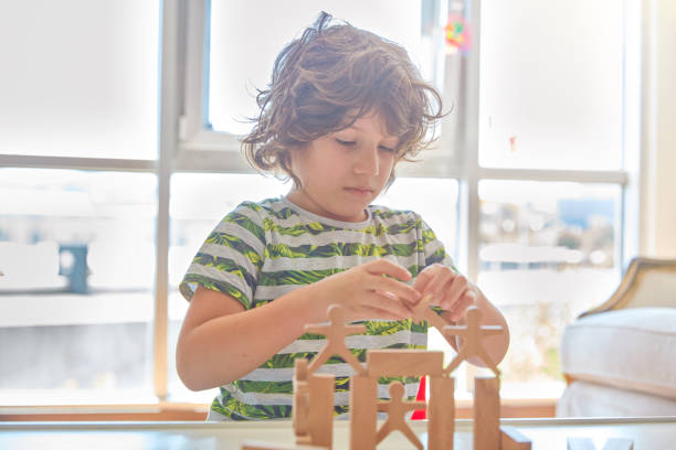 istock Cute little boy Playing with Wooden Blocks 1323060304