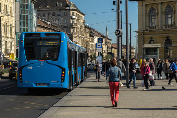 View of urban lifestyle with the bus, road traffic transportation and crowd of people on the street in Budapest, Hungary Budapest, Hungary - October 11, 2019: View of urban lifestyle with the bus, road traffic transportation and crowd of people on the street in Budapest, Hungary bus hungary stock pictures, royalty-free photos & images