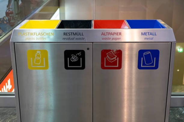 View of separating bin for plastic bottles, residual waste, waste paper and metal in Wien Hauptbahnhof, the main railway station in Vienna, Austria. stock photo