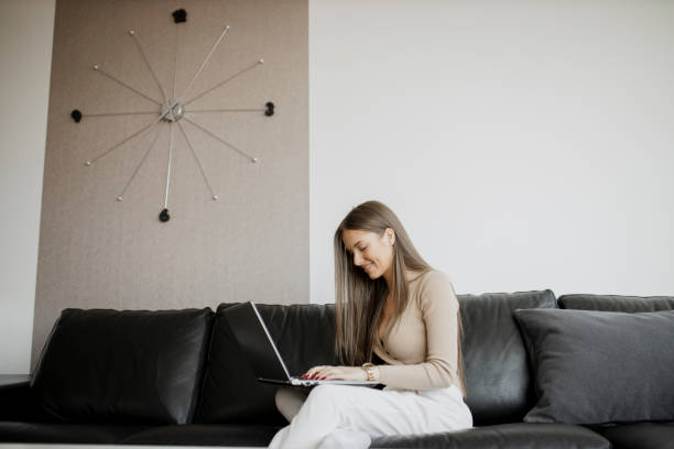 istock Young woman using her laptop, working and having video call at home office 1323069209