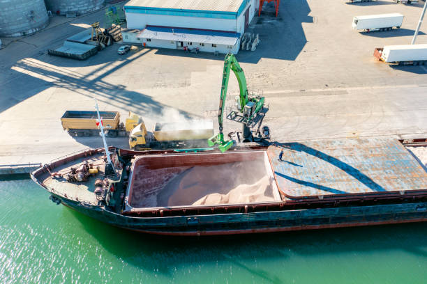 istock Aerial view of a large cargo ship unloading grain. 1323070024