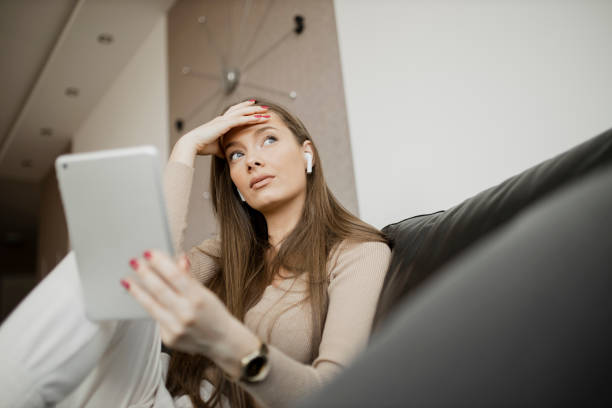 istock Anxiety woman using digital tablet at home 1323072010