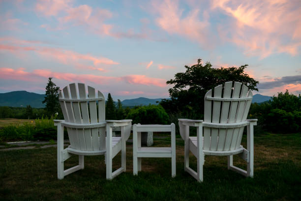 istock Relaxing Anirondack Chairs looking out on a beautiful mountain sunset 1323077901