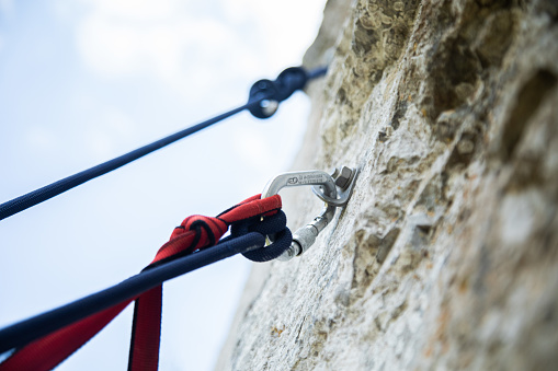 Man  getting ready for rock climbing at a climbing field outdoors