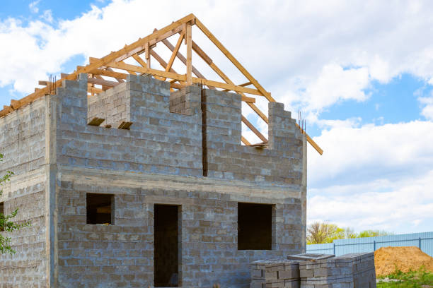 istock Construction of a private country house from a cinder block. Roof erection 1323081892